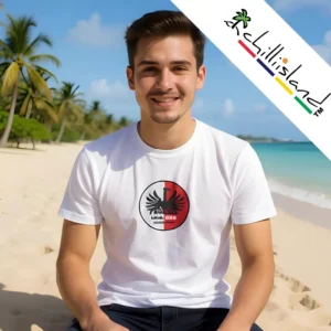 A smiling man in a white original Chilliisland T-shirt featuring a black and red Phoenix Beer design sits on a tropical beach, in Mauritius, with palm trees and a blue sky. "chillisland" logo above.