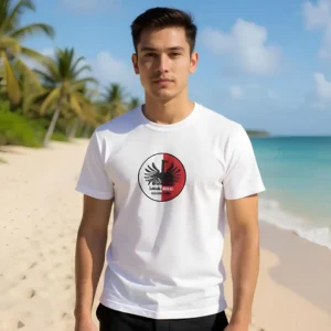 Man on a tropical Mauritius beach wearing a white Chilliisland T-shirt with a black and red patterned Phoenix Beer design, the original Brand Logo. Palm trees and turquoise ocean in the background; sunny day.