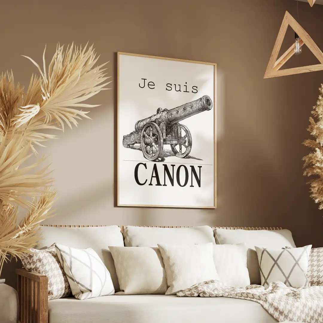 A living room features a framed art print of a cannon with the text "Je suis CANON" above a stylish sofa and decorative plants.