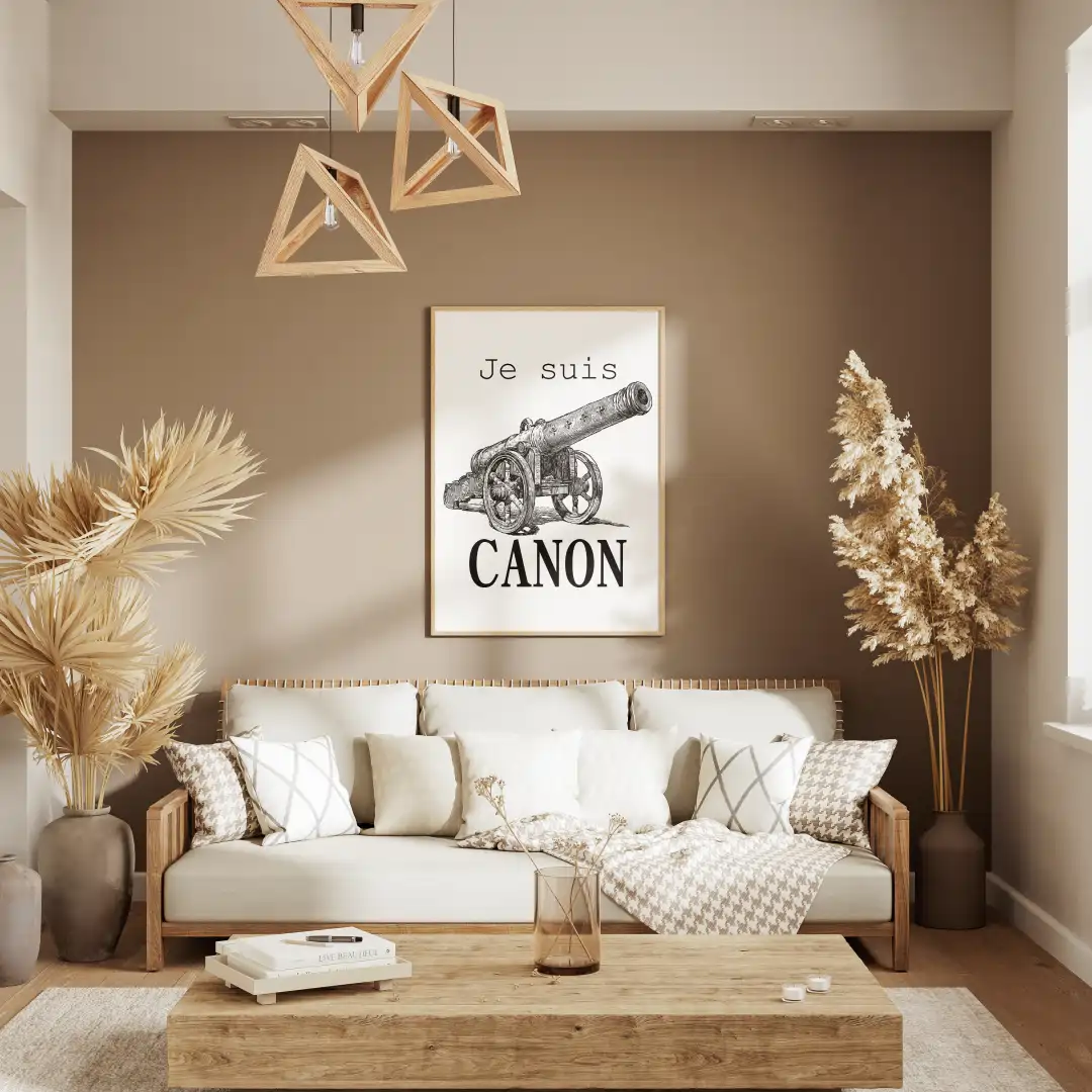 Modern living room featuring a light sofa, wooden coffee table, and a framed print of a cannon with the text "Je suis CANON" on the wall.