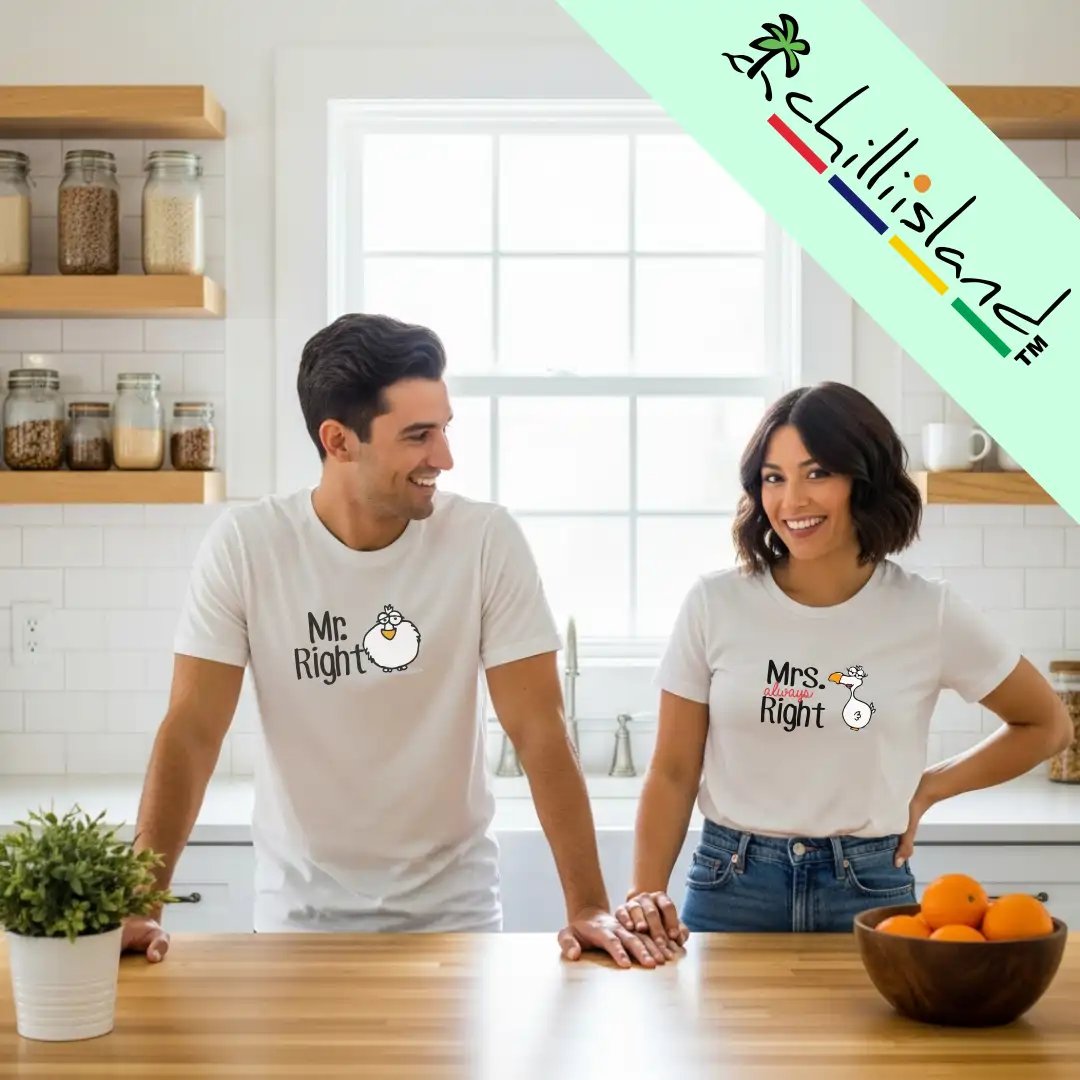 A couple in a bright kitchen wearing matching "Mr. Right" and "Mrs. Always Right" Chilliisland T-shirts share a lighthearted moment. The scene feels warm and cheerful.